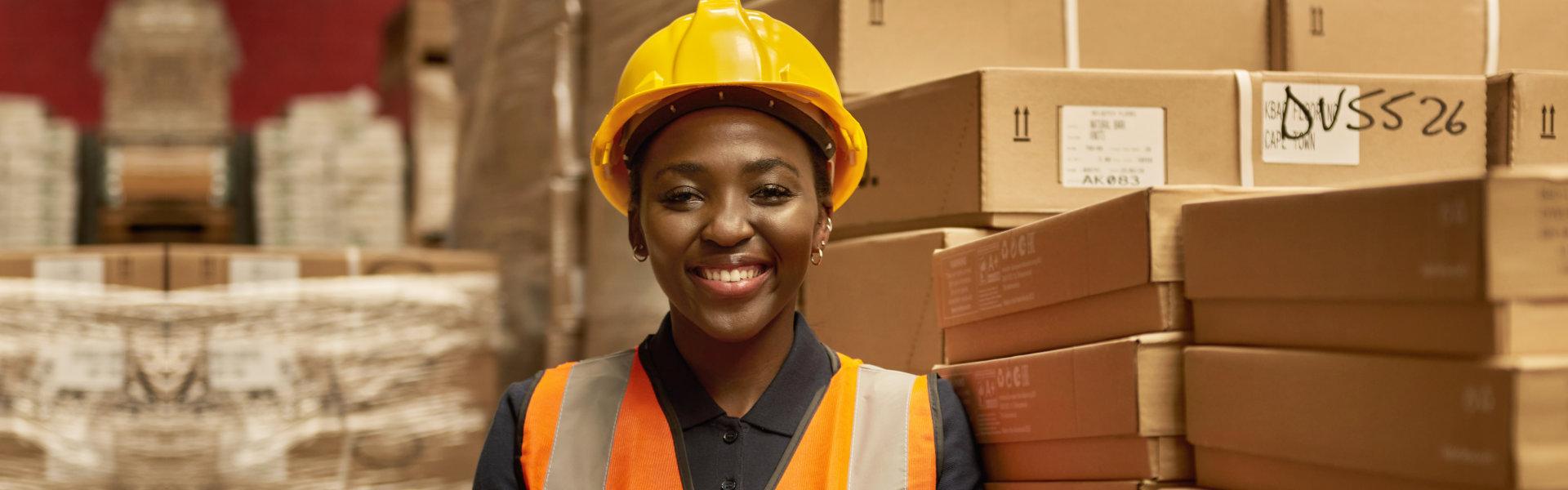 warehouse worker wearing a safety vest and helmet