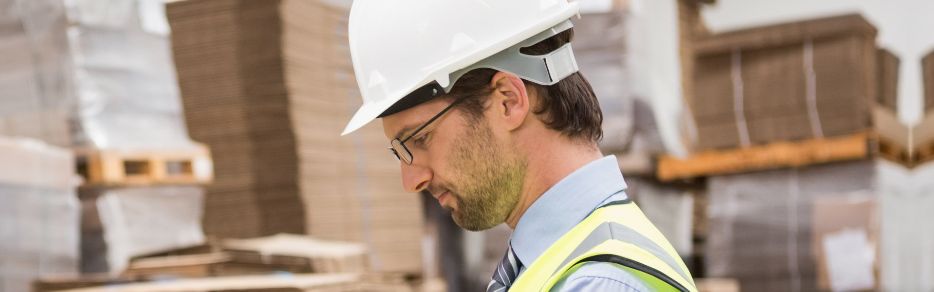 Warehouse worker checking his list on clipboard